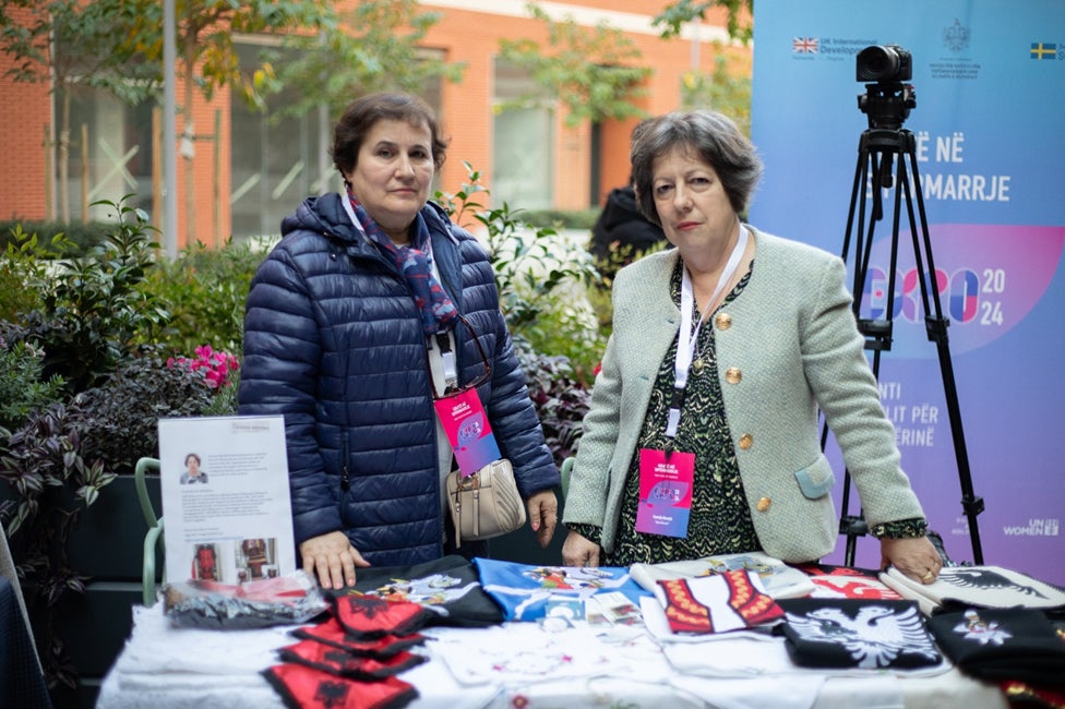 Kumrije Bejrushi (right), an artisan and business owner specializing in traditional costume embroidery.