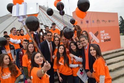 UN Women Representative David Saunders and the Swedish Ambassador Johan Ndisi take a selfie with young activists on International Day to End Violence against Women Photo credit: Together for Life NGO